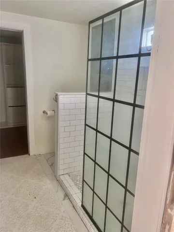 a bathroom with a glass shower door