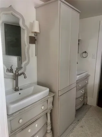 a bathroom with a sink and mirror