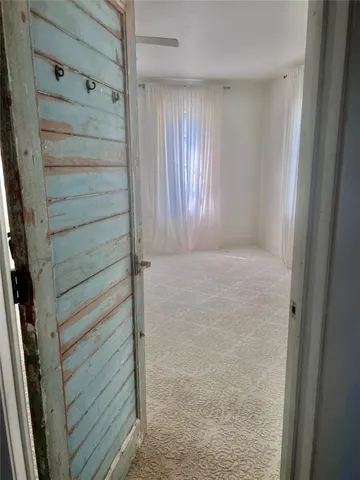 a view of a room with wooden floor and cabinet