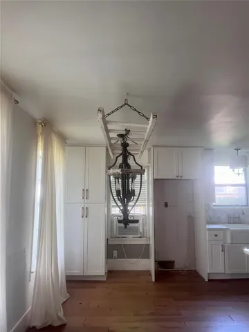 en empty room with windows and wooden floor