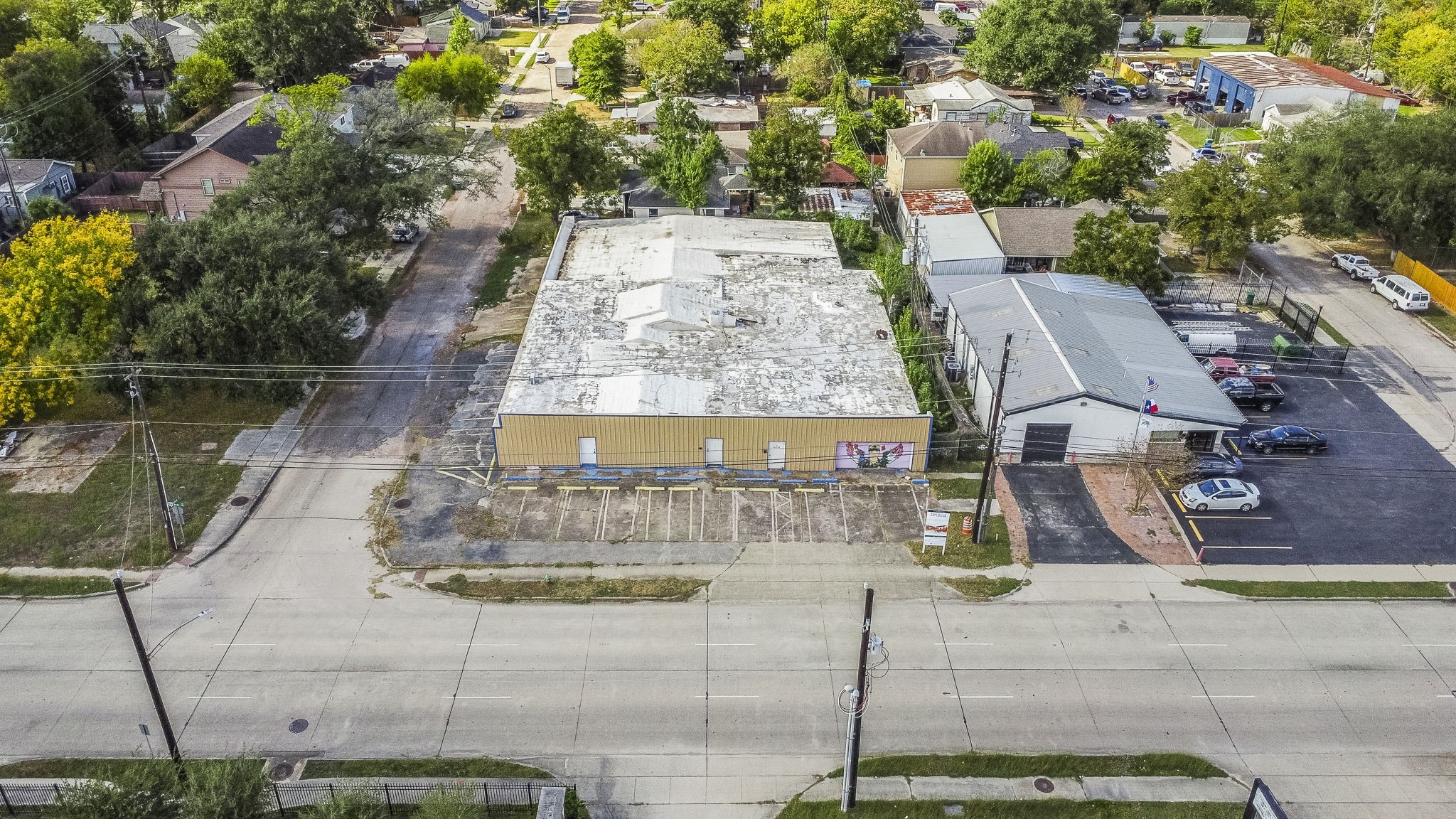 1018 Shaver Street Pasadena, TX 77506 - Photo 41 of 43 Front aerial view of the property showcasing its wide street frontage, multiple parking spaces, and placement within a well-established neighborhood.