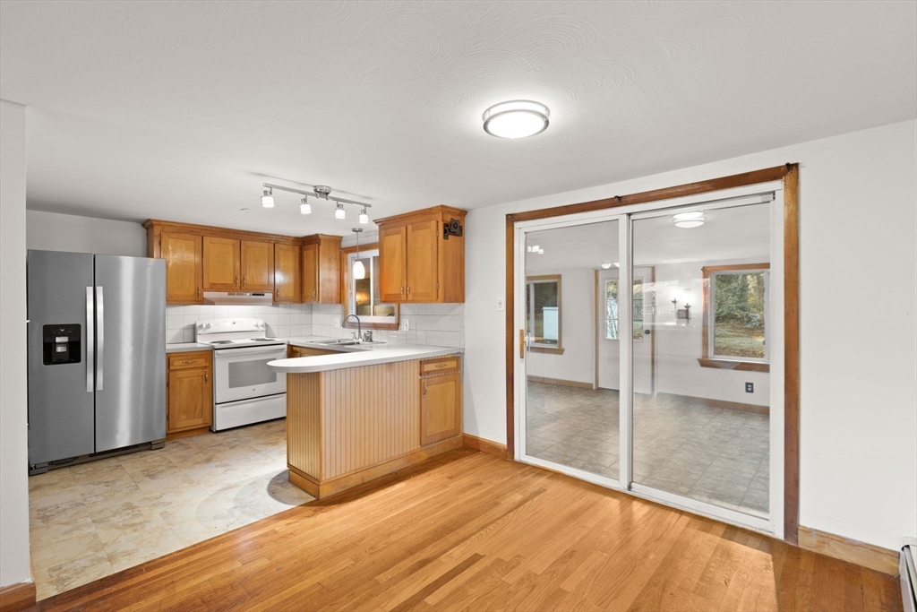 53 Forge Road Assonet, MA 02702 - Photo 11 of 39 a kitchen with a refrigerator and white cabinets