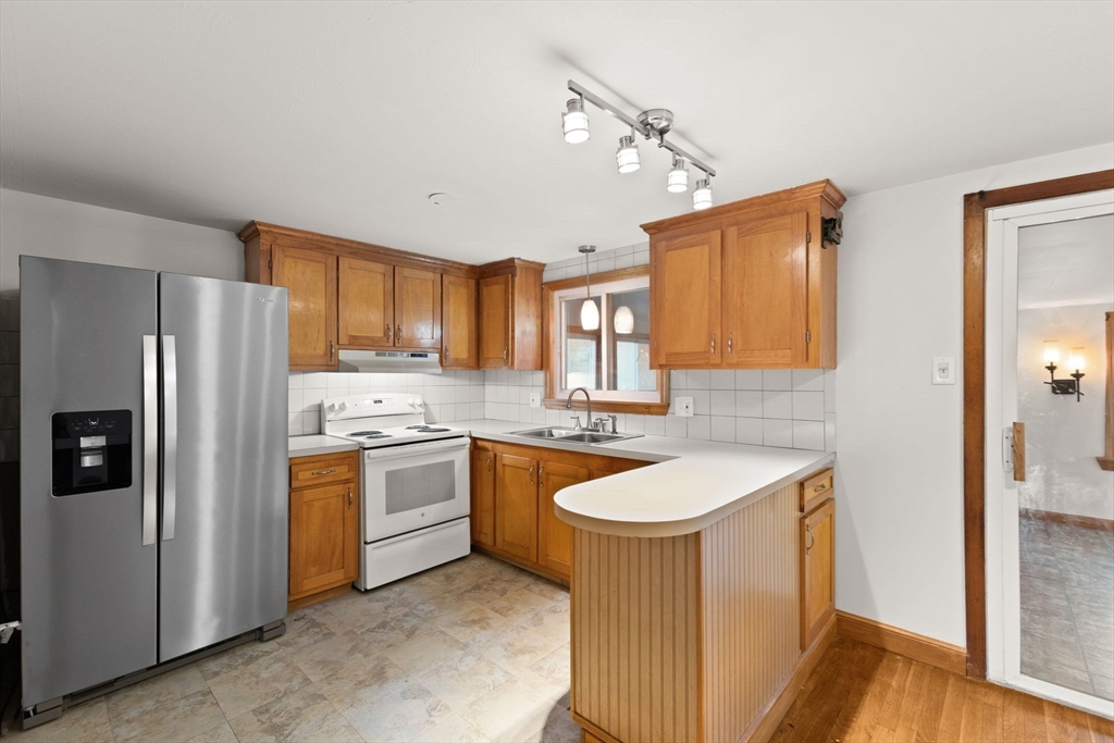 53 Forge Road Assonet, MA 02702 - Photo 13 of 39 a kitchen with a sink stove and refrigerator