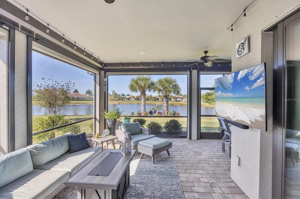 13057 Rinella Street Venice, FL 34293 - Photo 15 of 85 a living room with furniture and a floor to ceiling window