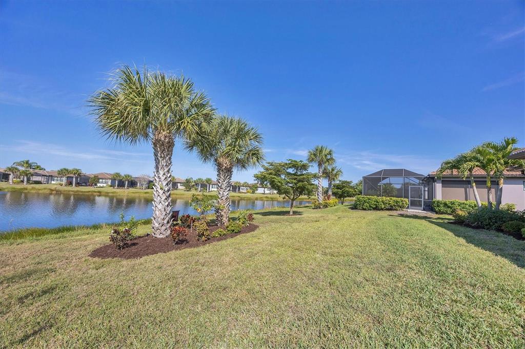13057 Rinella Street Venice, FL 34293 - Photo 24 of 85 a view of a lake with a building in the background