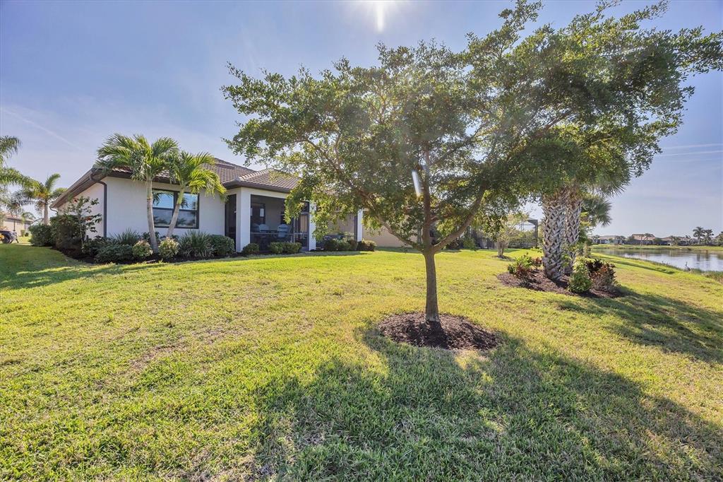 13057 Rinella Street Venice, FL 34293 - Photo 29 of 85 a house with huge green field in front of it