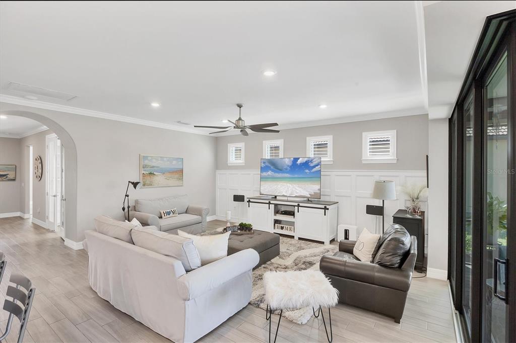 13057 Rinella Street Venice, FL 34293 - Photo 33 of 85 a living room with furniture and a view of kitchen