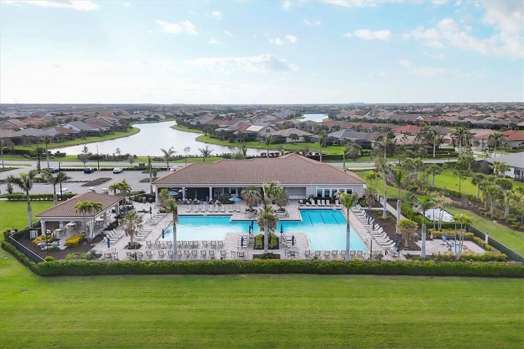 13057 Rinella Street Venice, FL 34293 - Photo 65 of 85 an aerial view of a house with a garden and lake view