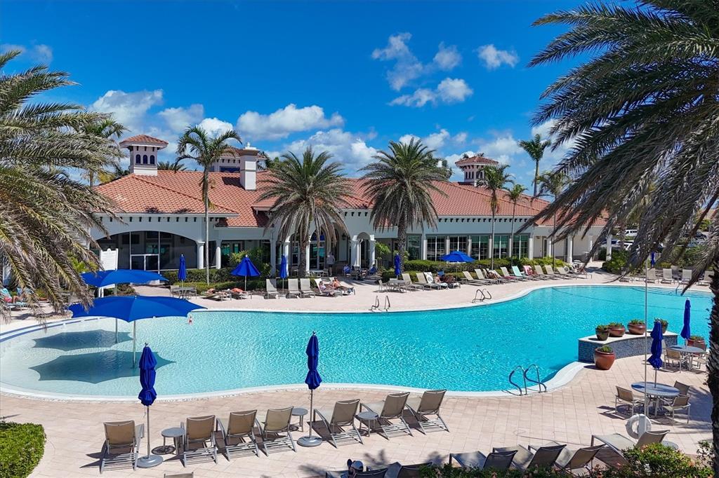 13057 Rinella Street Venice, FL 34293 - Photo 69 of 85 a view of a swimming pool with a table and chairs under an umbrella