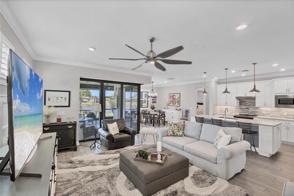 13057 Rinella Street Venice, FL 34293 - Photo 8 of 85 a living room with furniture kitchen view and a large window