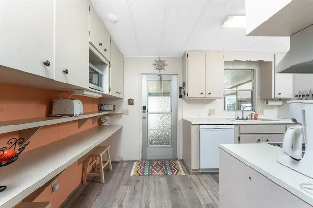 a kitchen with a sink stainless steel appliances and cabinets