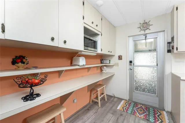 a kitchen with a refrigerator and a window