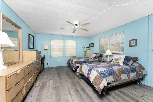 a bedroom with two beds and a chandelier