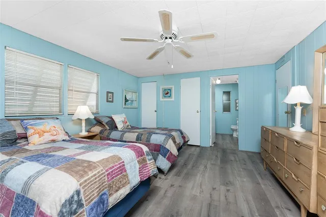 a bedroom with bed and a chandelier