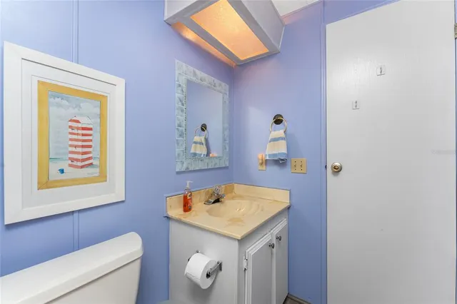 a bathroom with a sink a toilet and mirror