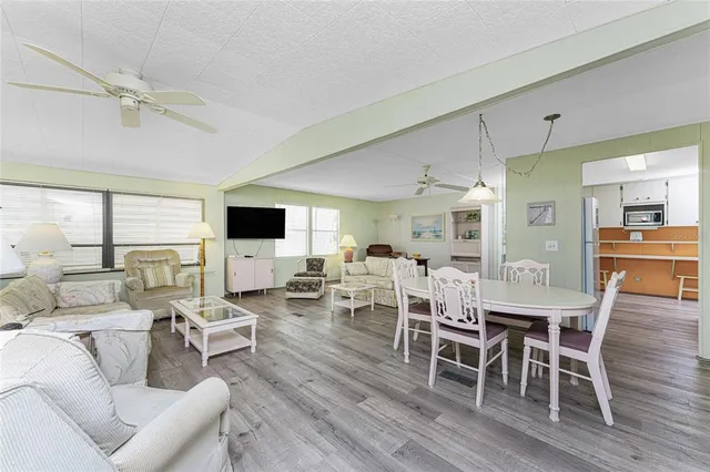 a living room with furniture wooden floor and a flat screen tv