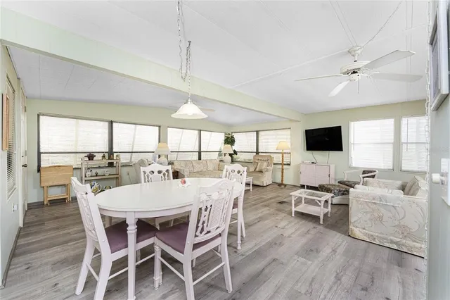 a view of a dining room with furniture window and wooden floor