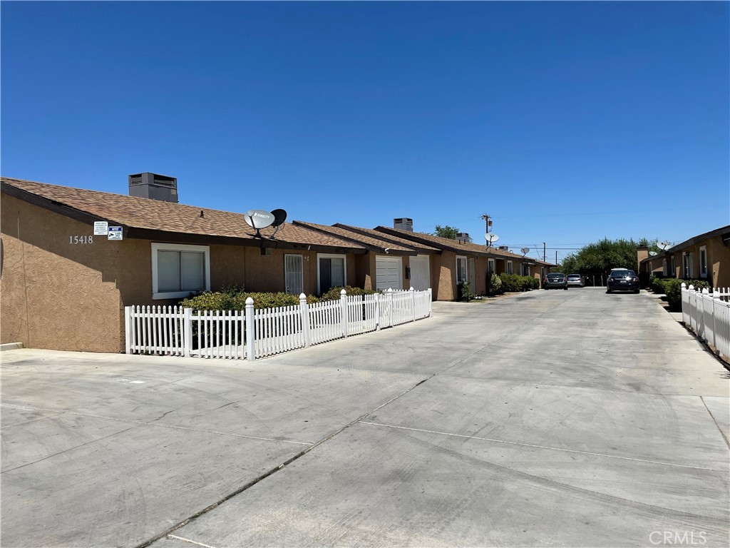 15418 Bear Valley Road, Unit 8 Victorville, CA 92395 - Photo 1 of 8 a view of a house with a outdoor space