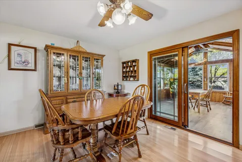 a dining room with furniture a chandelier and wooden floor
