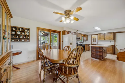 a dining room with furniture a window and wooden floor