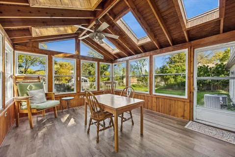 a view of a room with wooden floor and furniture