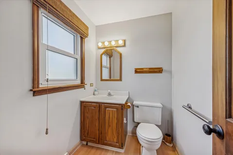 a bathroom with a toilet sink and mirror