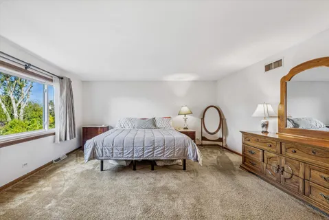 a bed room with a bed and a large window