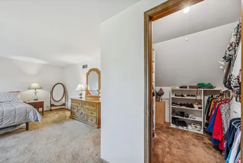 a view of a bedroom with bed and workspace