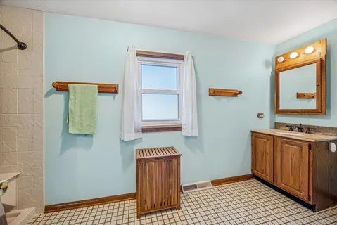 a bathroom with a sink a mirror and shower
