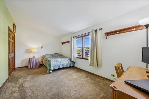 a bedroom with a bed and a table in it