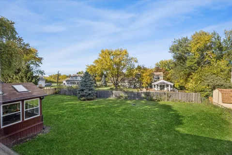 a view of a house with a yard porch and sitting area
