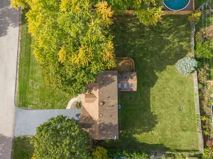 an aerial view of a house with a yard