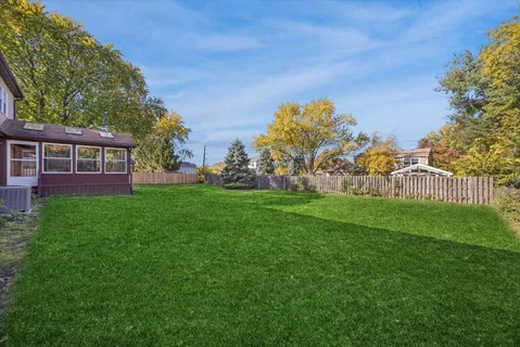 a view of house with garden space and trees