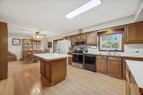 a kitchen with a stove sink and cabinets