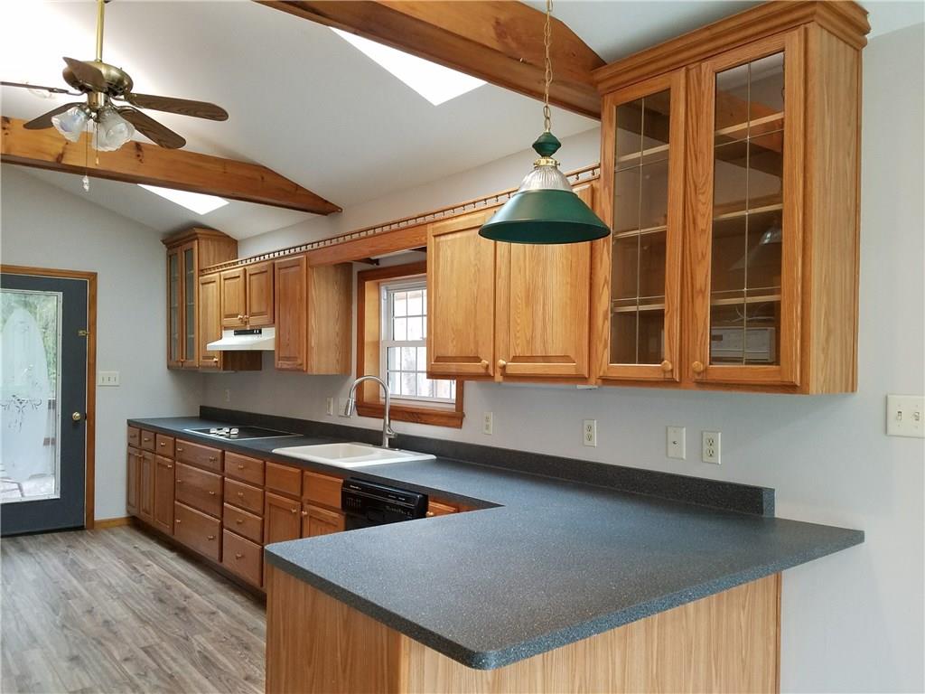 154 Stoup Road Mars, PA 16046 - Photo 7 of 25 Large Kitchen with brand new flooring! Glass door to large covered deck. Open to Breakfast Room. Ceiling fan/light & Beamed ceiling with sky lights for extra brightness! Eat-at counter space.
