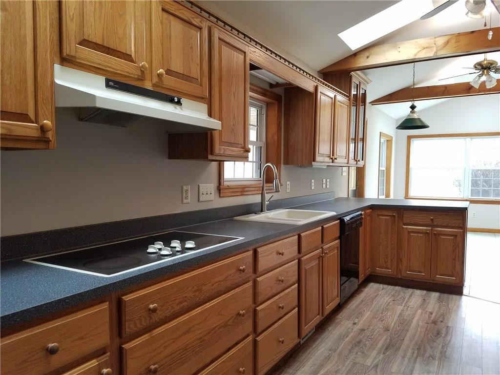 154 Stoup Road Mars, PA 16046 - Photo 9 of 25 Large Kitchen with brand new flooring! Glass door to large covered deck. Open to Breakfast Room. Ceiling fan/light & Beamed ceiling with sky lights for extra brightness! Eat-at counter space.