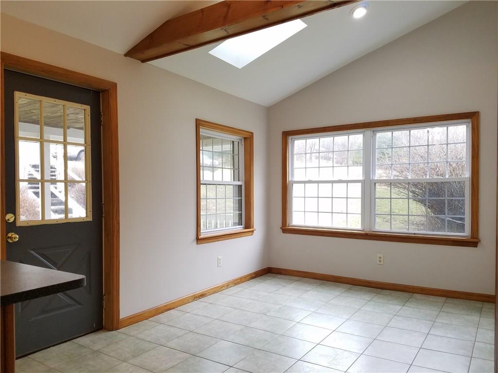 154 Stoup Road Mars, PA 16046 - Photo 10 of 25 Breakfast Room adjacent to Kitchen has ceramic floor, beamed vaulted ceiling with sky light. Exterior door to covered deck! Adjacent to Dining Room & Kitchen.