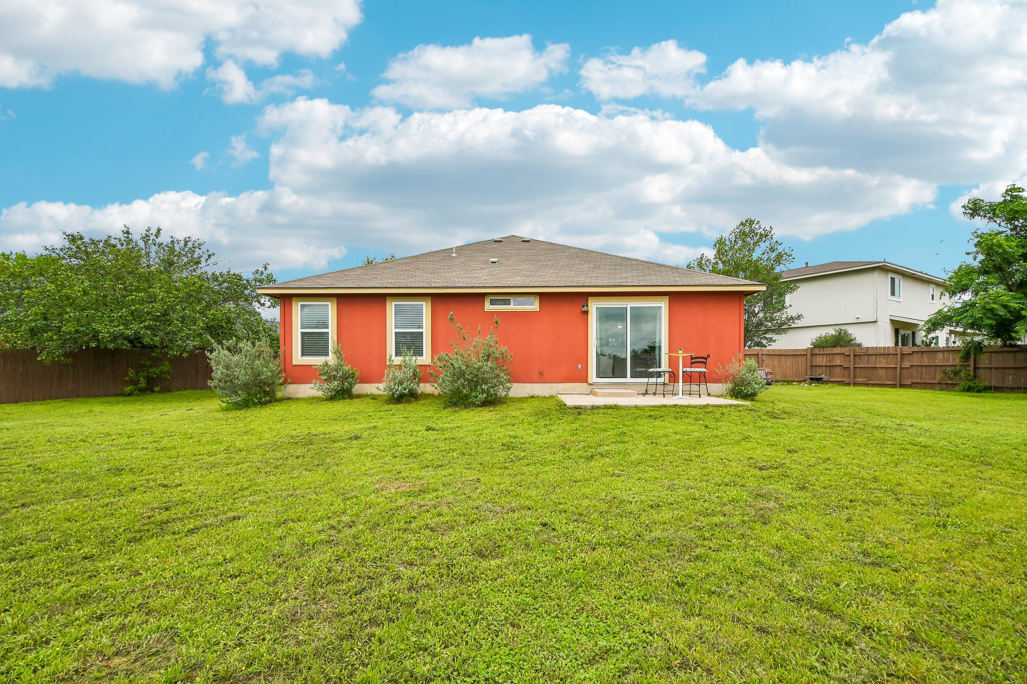 125 Mason Reed Cove Kyle, TX 78640 - Photo 37 of 39 a view of a house with a big yard and potted plants