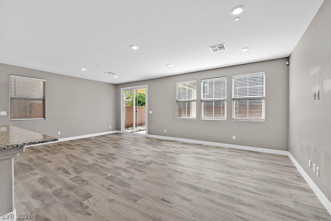 2823 Turnstone Ridge Street Henderson, NV 89044 - Photo 5 of 25 Recessed lighting illuminates wood flooring and a convenient sliding door to the outdoor area.