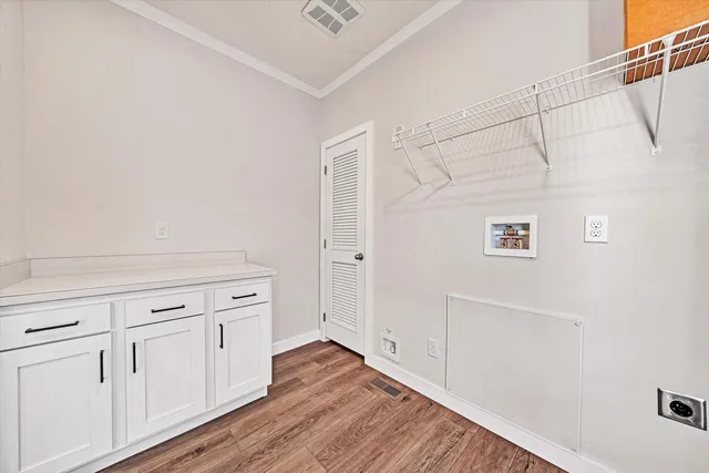 a view of an empty room and wooden floor