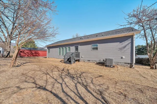 a view of a house with a yard covered in snow