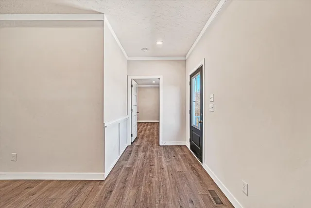 a view of a hallway with wooden floor