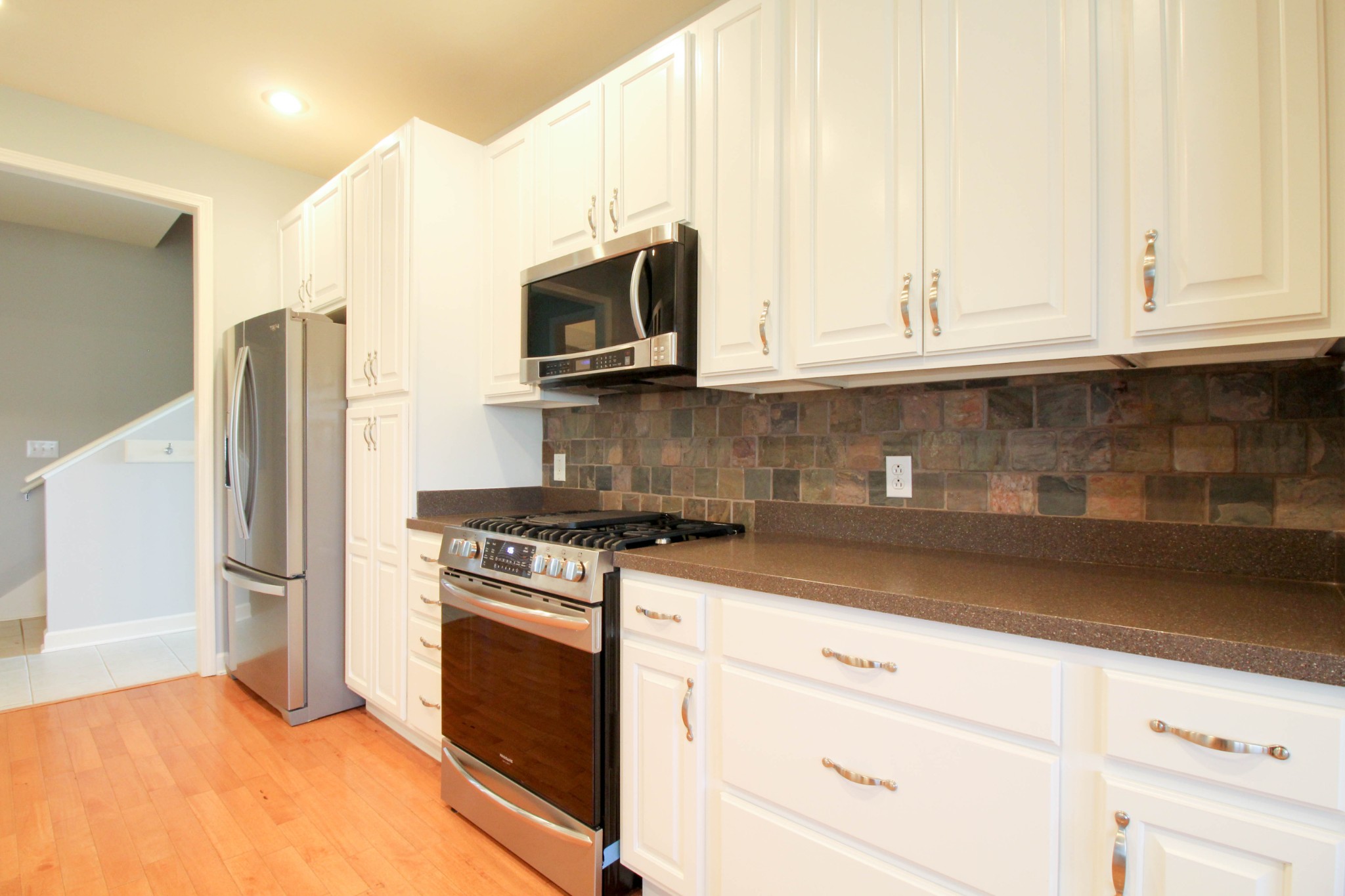 4076 Airport Road Springfield, TN 37172 - Photo 9 of 11 a kitchen with stainless steel appliances granite countertop a stove a microwave and a refrigerator