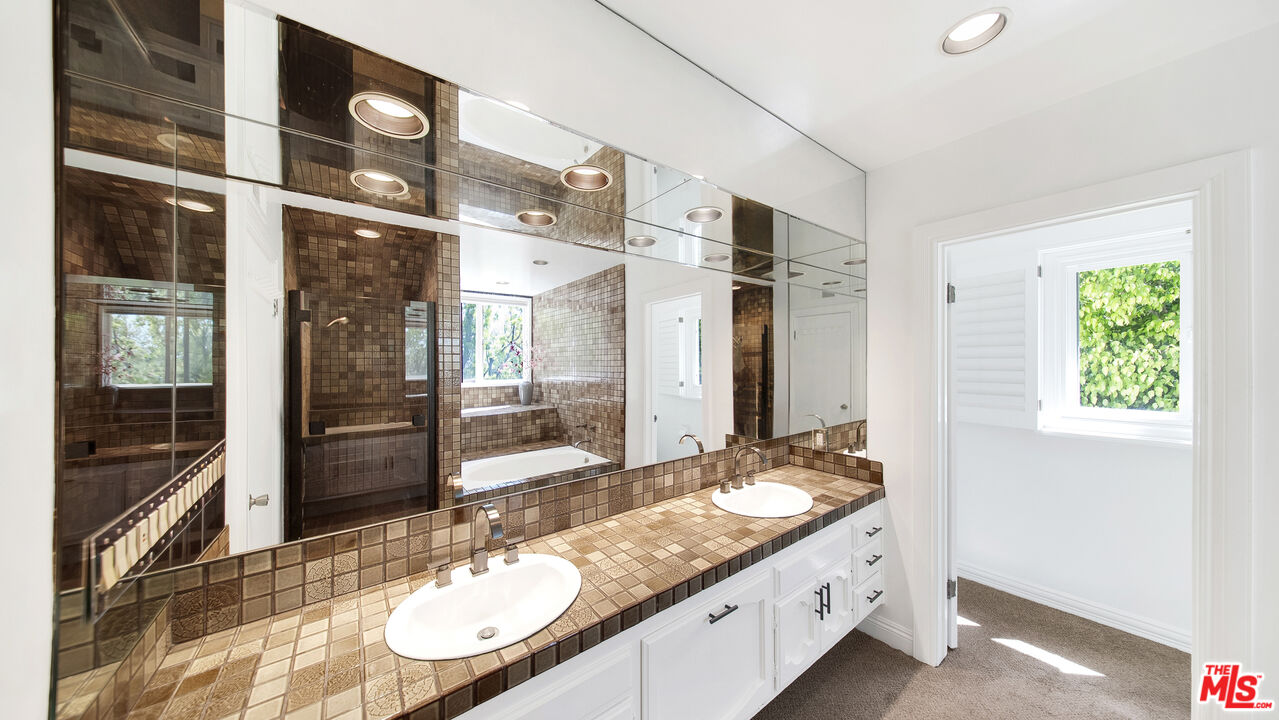 2312 Kimridge Road Beverly Hills, CA 90210 - Photo 37 of 60 a bathroom with a granite countertop double vanity and a mirror