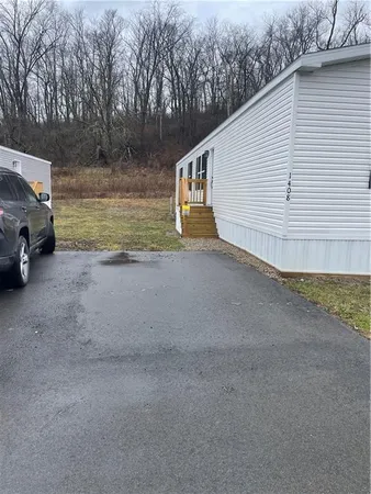 a view of a house with a yard and garage