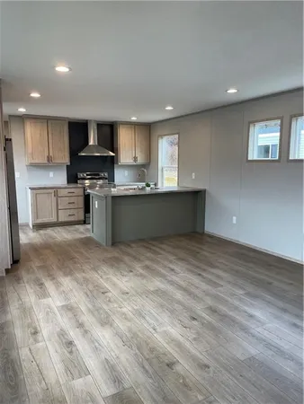 a kitchen with stainless steel appliances granite countertop a sink a stove top oven a counter space and cabinets