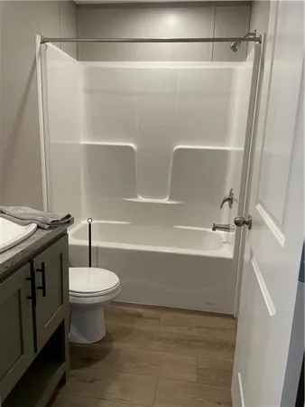 an empty room with a wooden door and white door