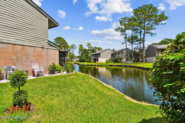 a view of a lake with a house in the background