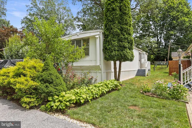 a view of a house with a yard and garden