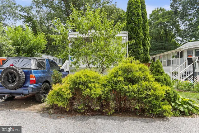 a backyard of a house with lots of green space and fountain